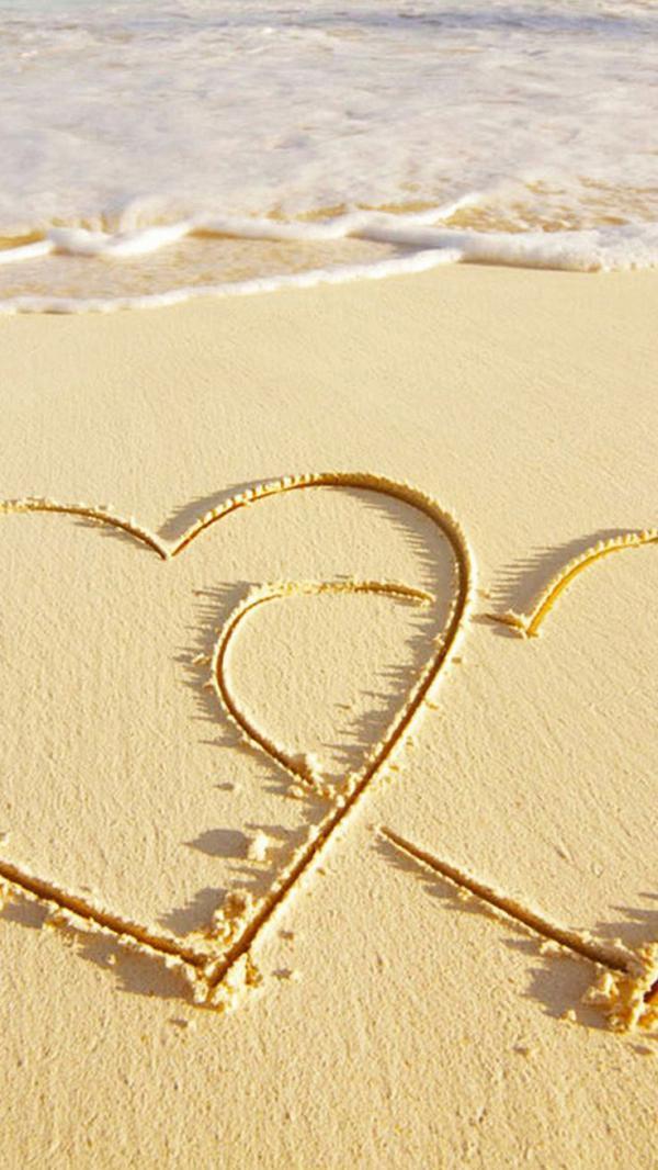 Szerelem szív tengeri homokkal a tengerparton iPhone háttérkép