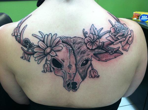 Fél szarvas koponya tetoválás a hátán