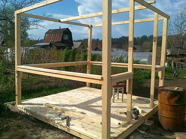 installatie van het frame van een houten tuinhuisje